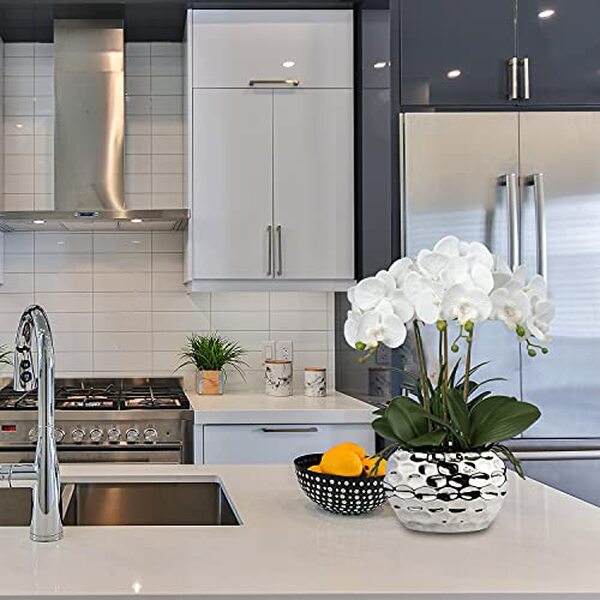 Découvrez notre avis détaillé sur l'orchidée blanche artificielle oairse en céramique de 44 cm : qualité, design et durabilité pour votre décoration intérieure.